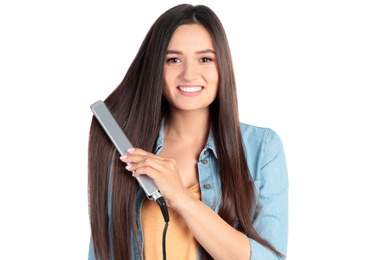 Photo of Young woman using hair iron on white background