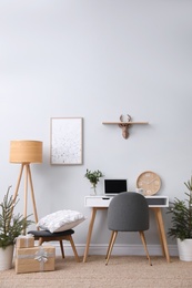 Stylish room interior with potted fir trees decorated for Christmas