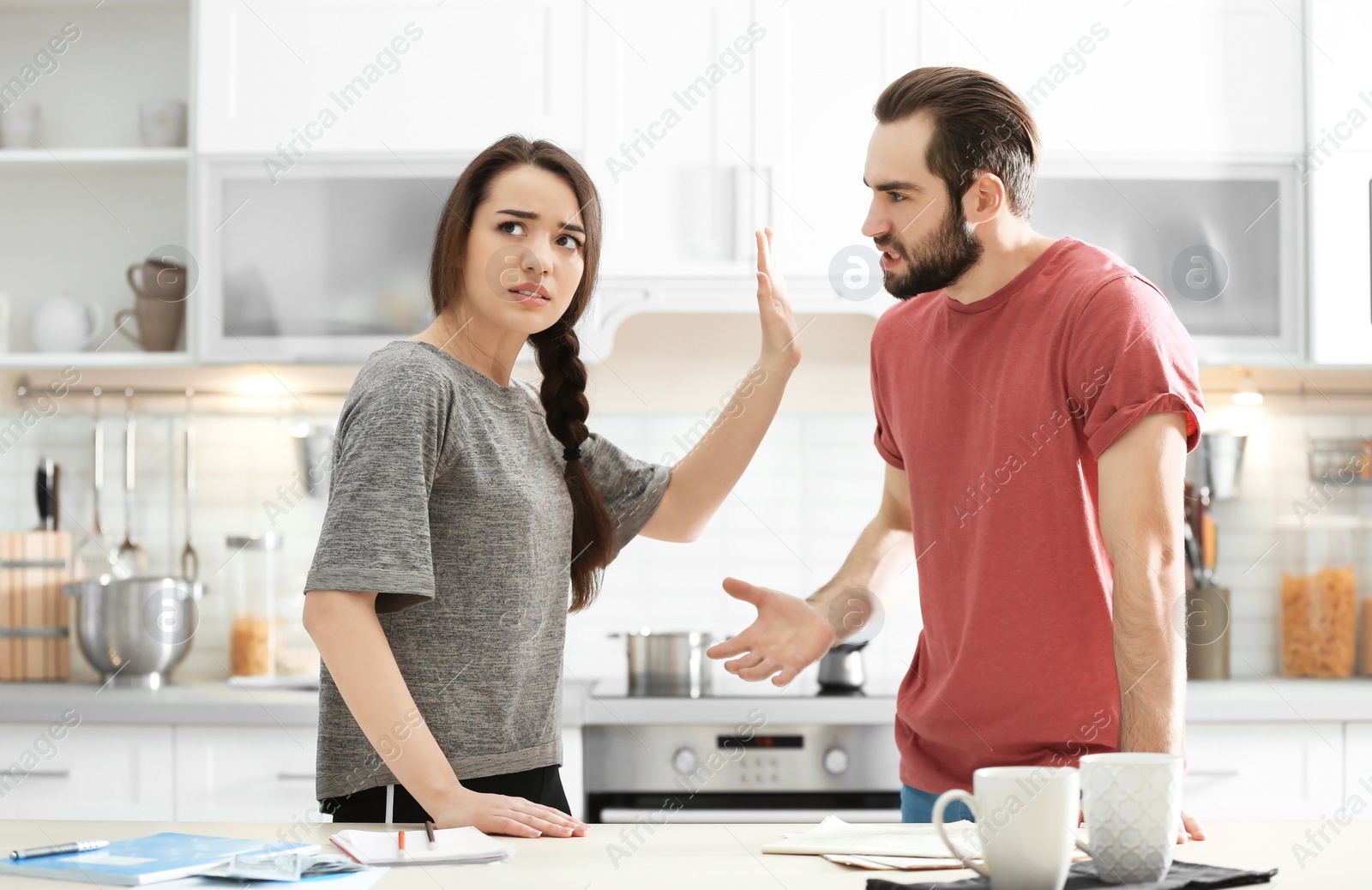 Photo of Young couple having argument in kitchen