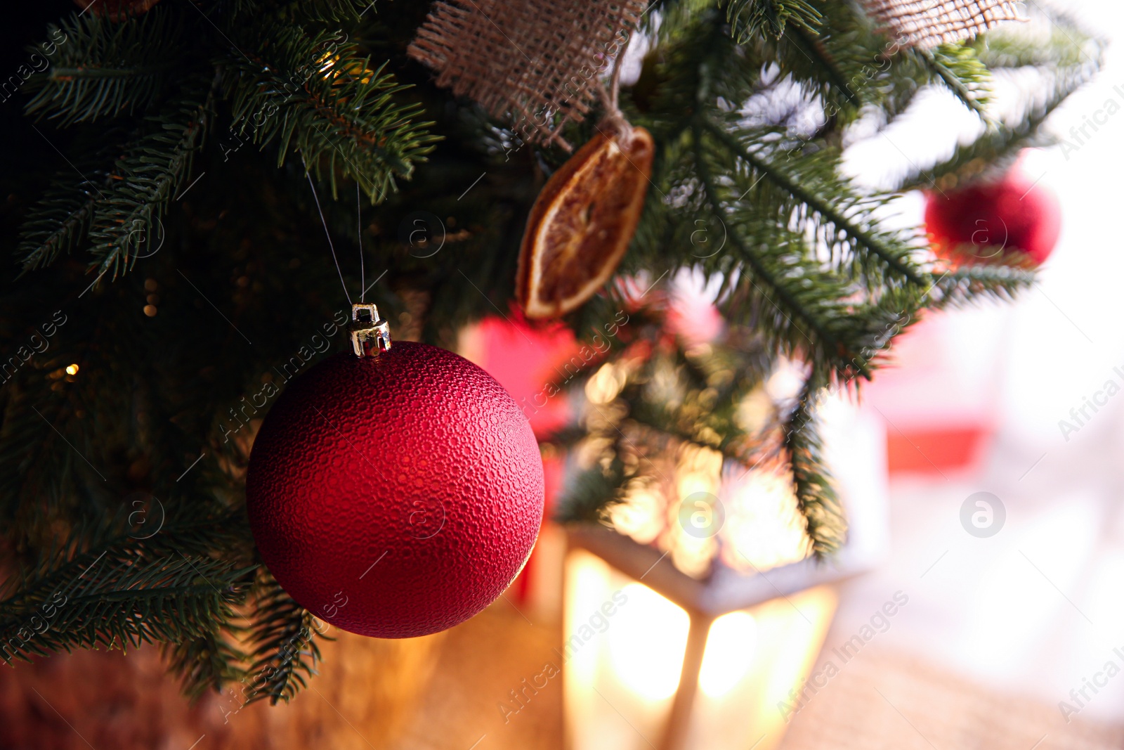 Photo of Beautiful Christmas tree decorated with festive lights and baubles indoors, closeup