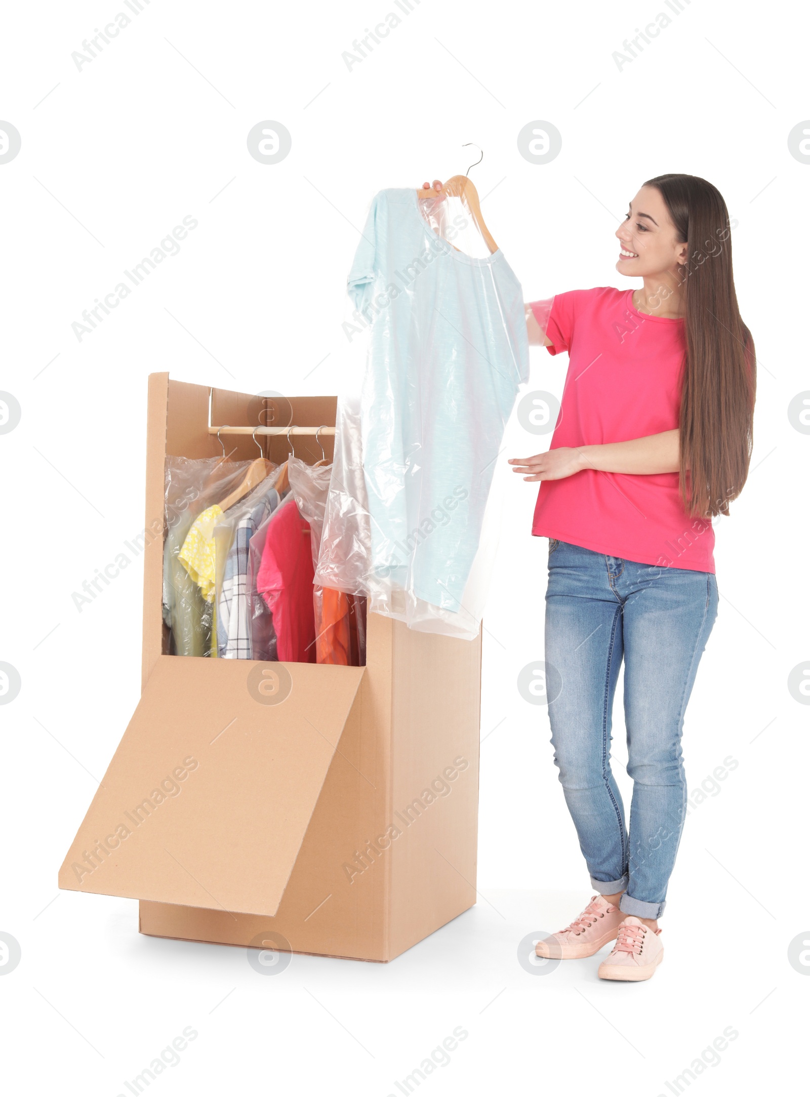 Photo of Young woman near wardrobe box on white background