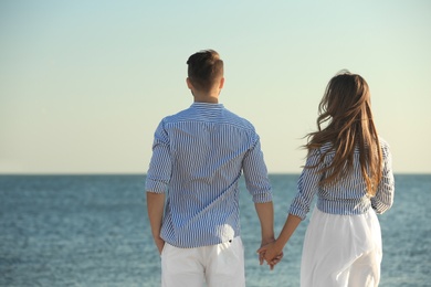 Happy young couple resting together on beach