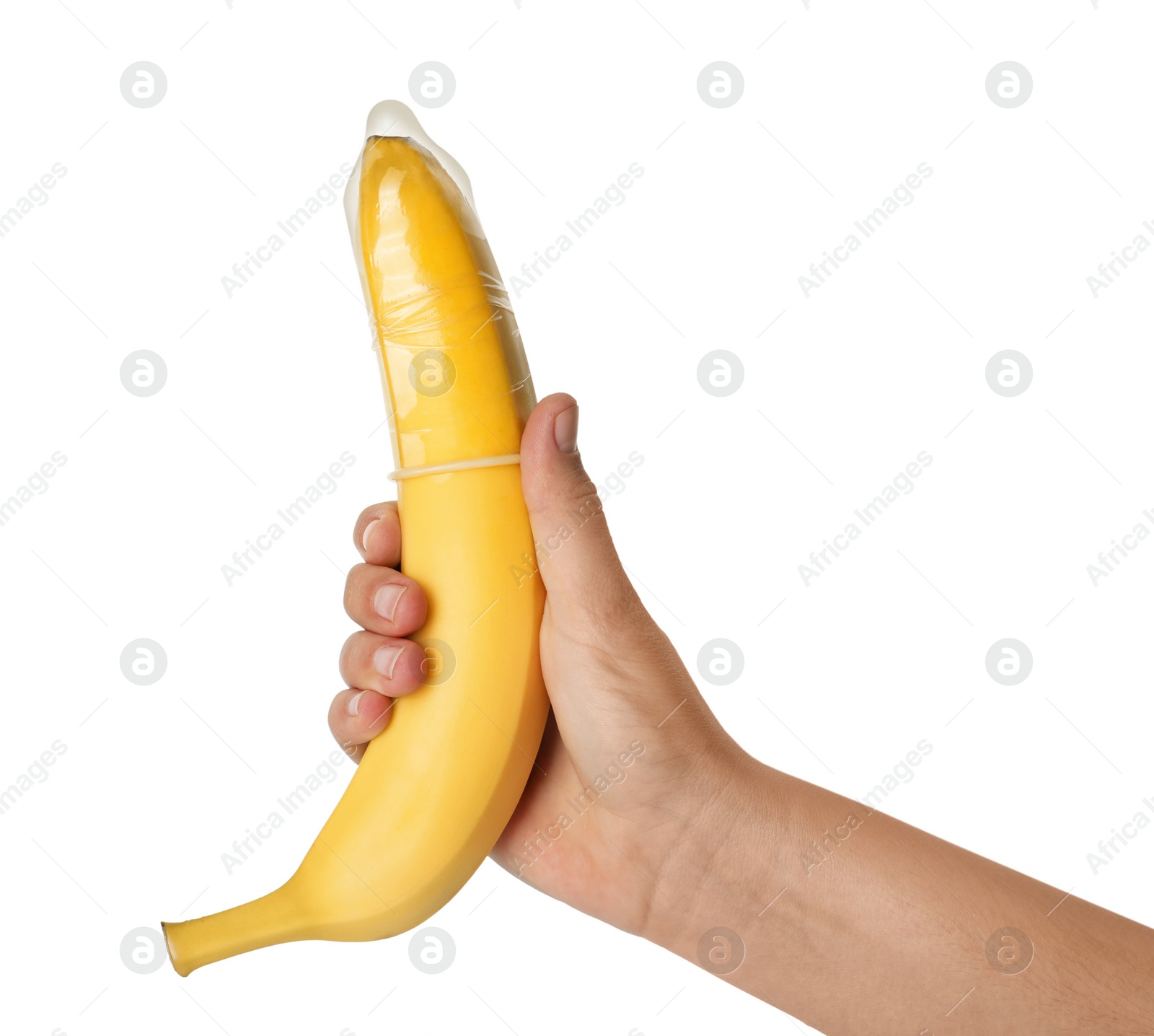 Photo of Woman holding banana in condom on white background, closeup. Safe sex concept