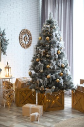 Stylish interior with decorated Christmas tree in living room