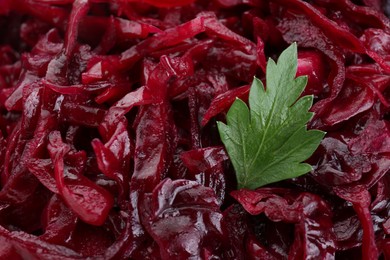 Tasty red cabbage sauerkraut with parsley as background, closeup