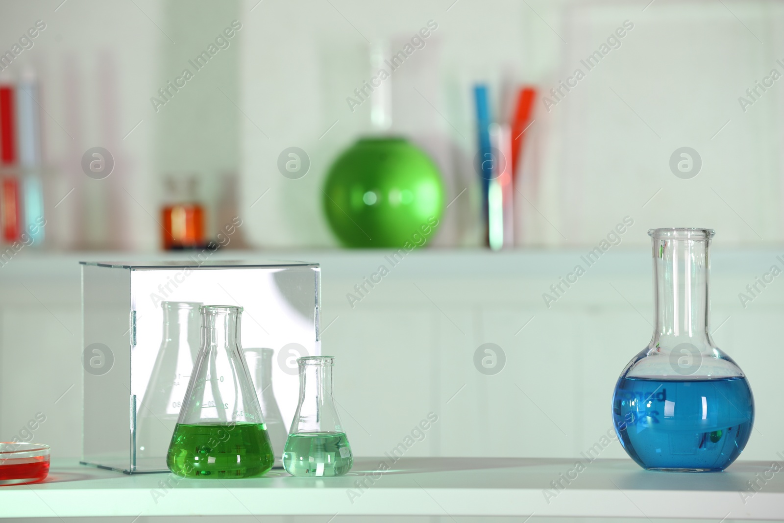 Photo of Laboratory analysis. Glass flasks with liquids on white table indoors