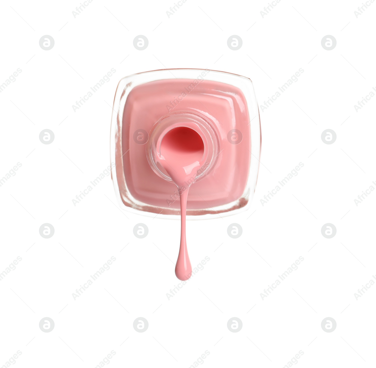 Photo of Pouring color nail polish from bottle on white background