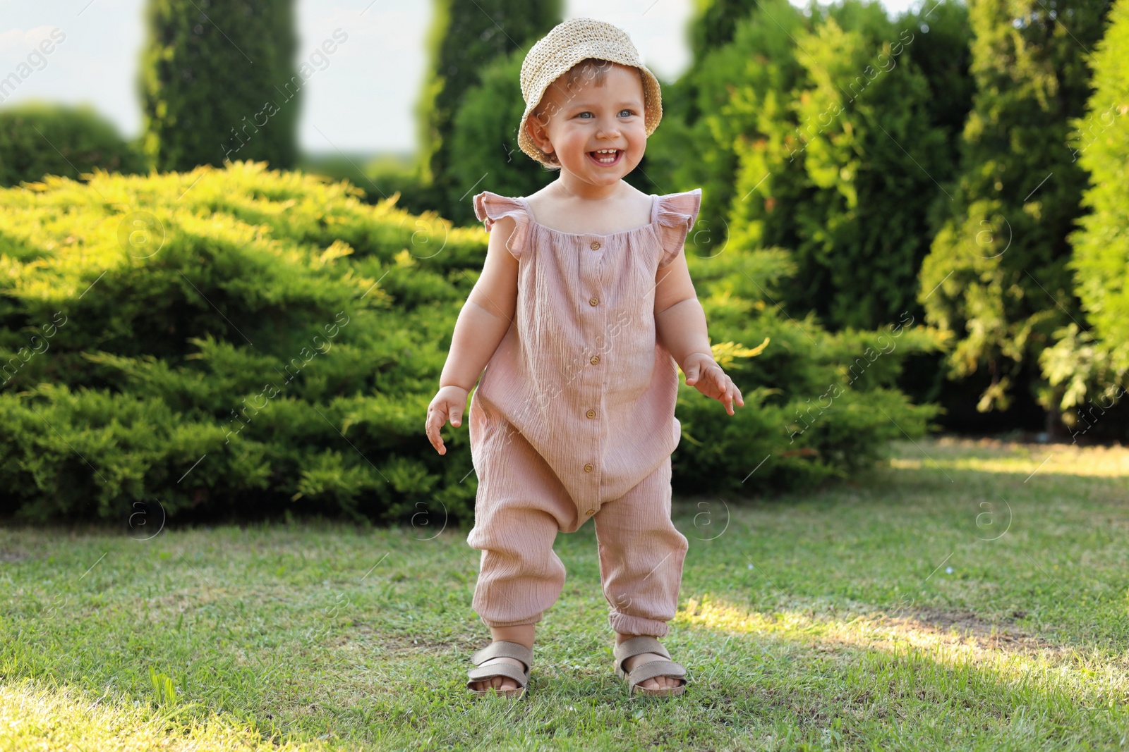 Photo of Cute little girl wearing stylish clothes outdoors on sunny day