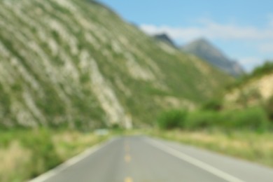 Photo of Blurred view of mountains and empty asphalt highway outdoors. Road trip