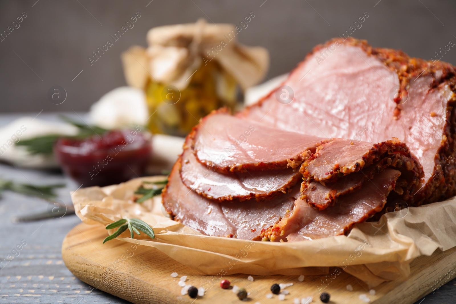 Photo of Delicious cooked ham served on wooden board, closeup