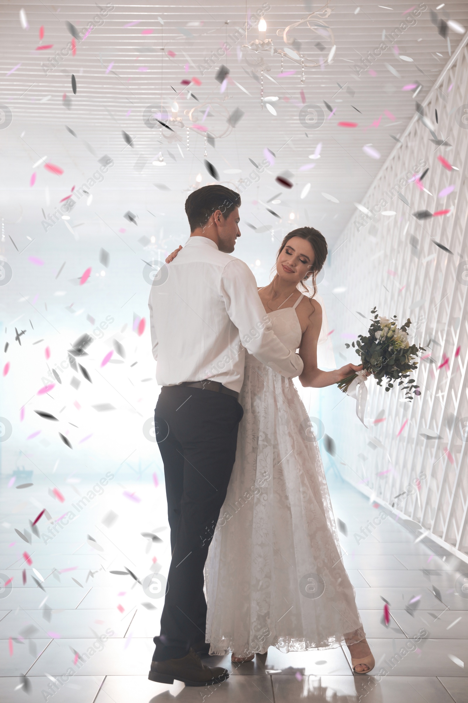 Image of Happy newlywed couple dancing together in festive hall