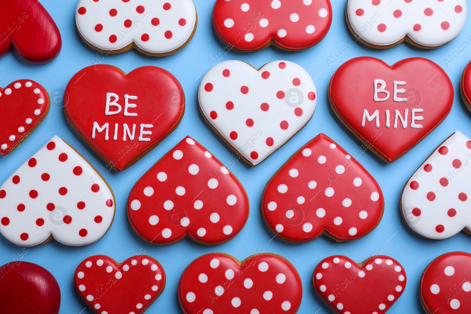 Photo of Delicious heart shaped cookies on light blue background, flat lay. Valentine's Day