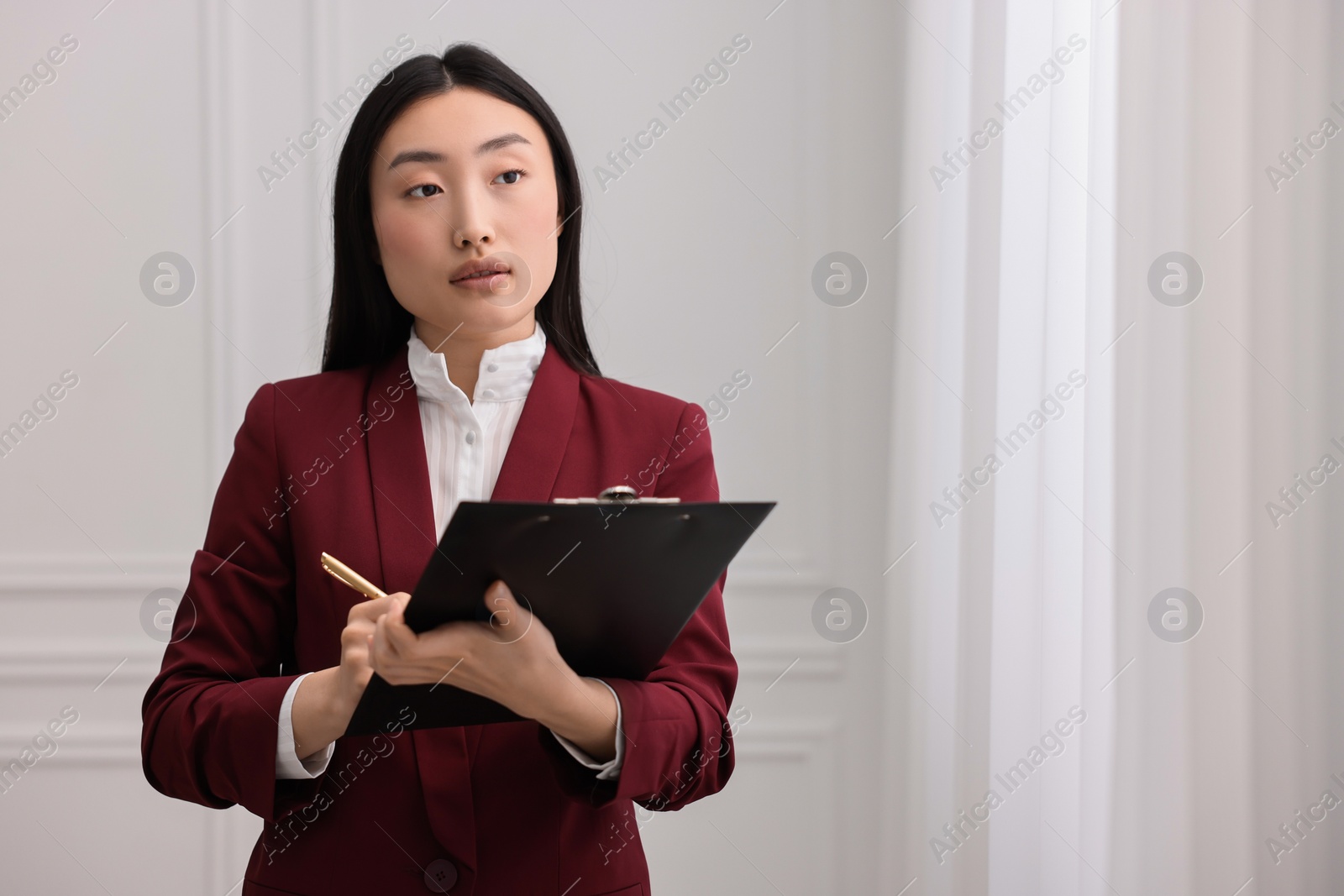 Photo of Portrait of notary with clipboard in office. Space for text