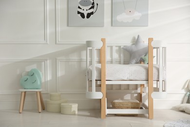 Photo of Baby room interior with stylish furniture and toys