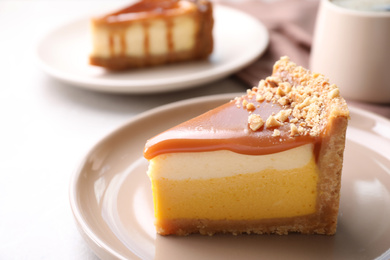 Photo of Piece of delicious cake with caramel served on light table