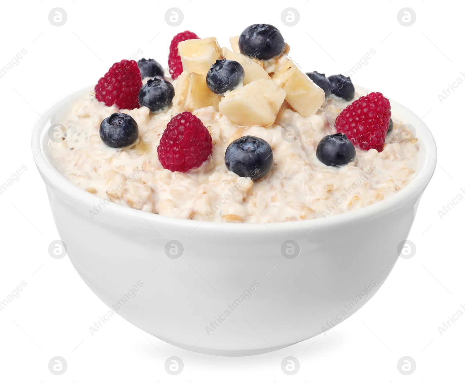 Photo of Tasty boiled oatmeal with berries and banana in bowl isolated on white