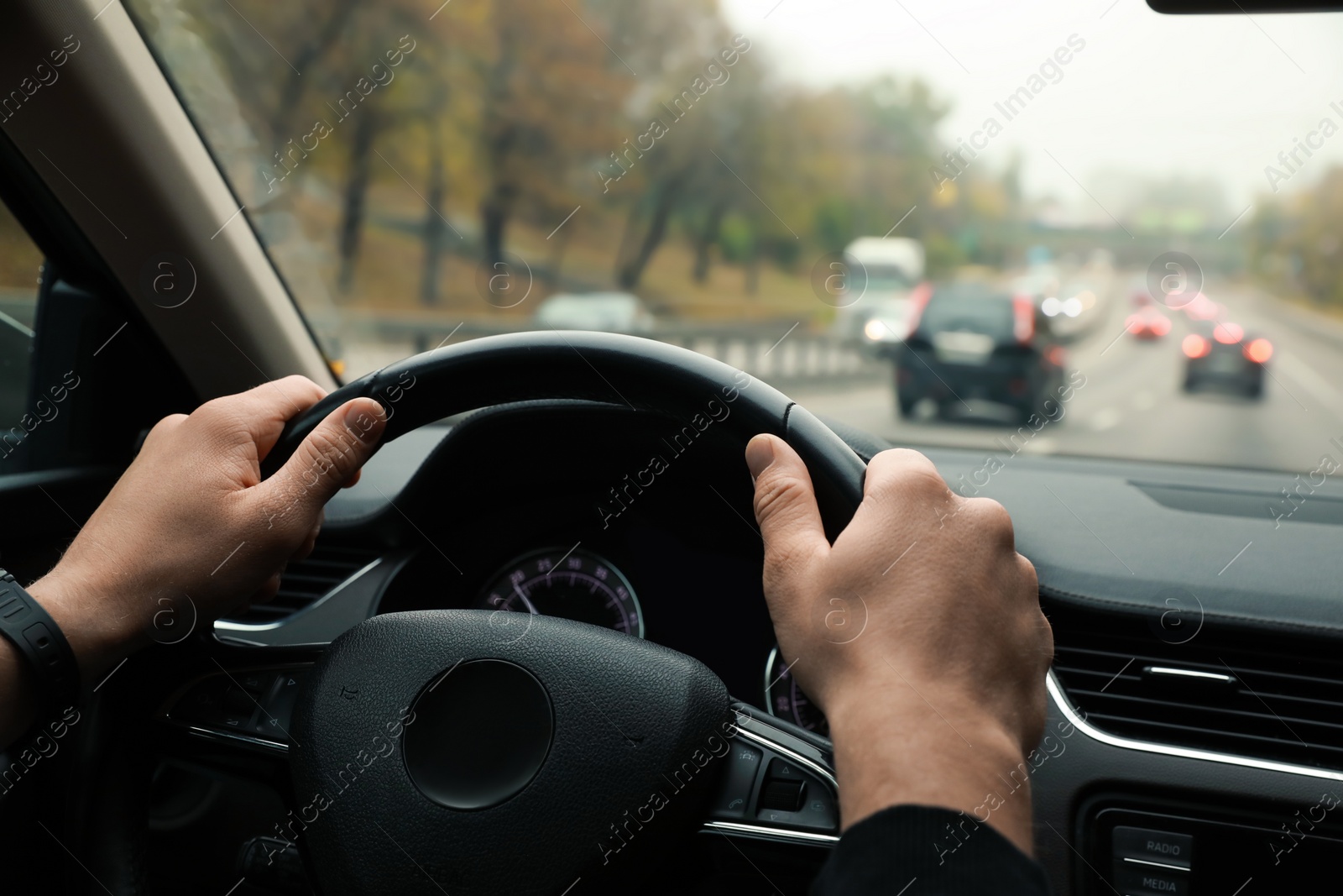 Photo of Man driving his car, closeup. Traffic rules