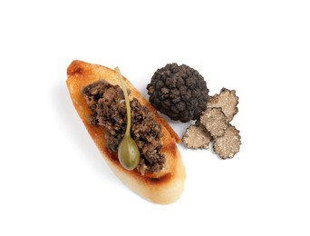 Tasty bruschetta with truffle paste and caper on white background, top view