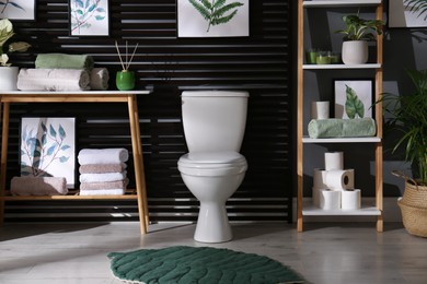 Stylish bathroom interior with toilet bowl and other essentials