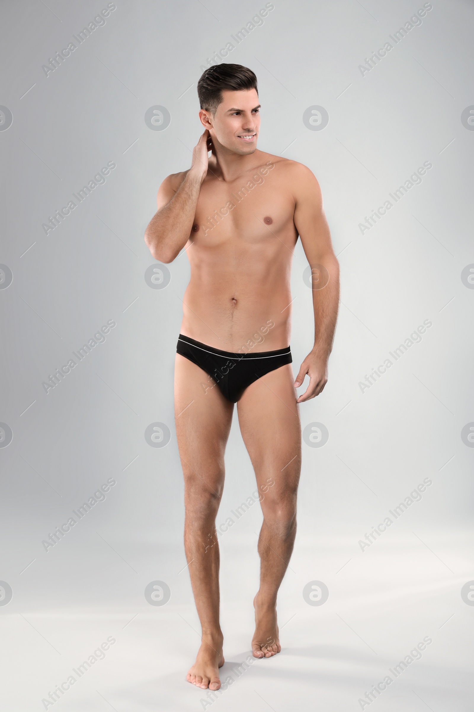 Photo of Handsome man in black underwear on light grey background