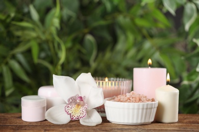 Photo of Beautiful spa composition with sea salt and candles on wooden table