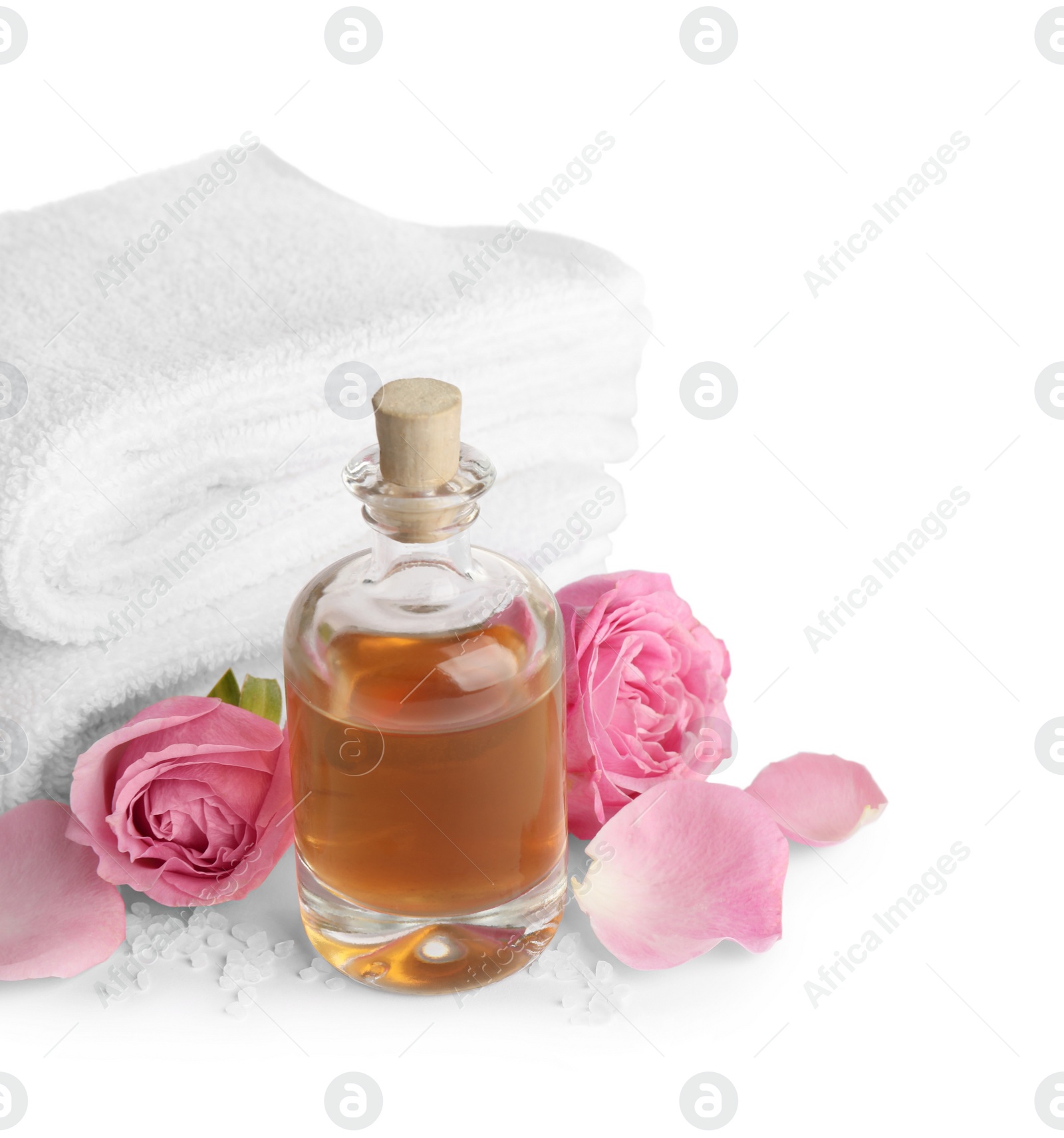 Photo of Spa composition with oil, pink flowers and towels on white background