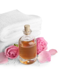 Photo of Spa composition with oil, pink flowers and towels on white background