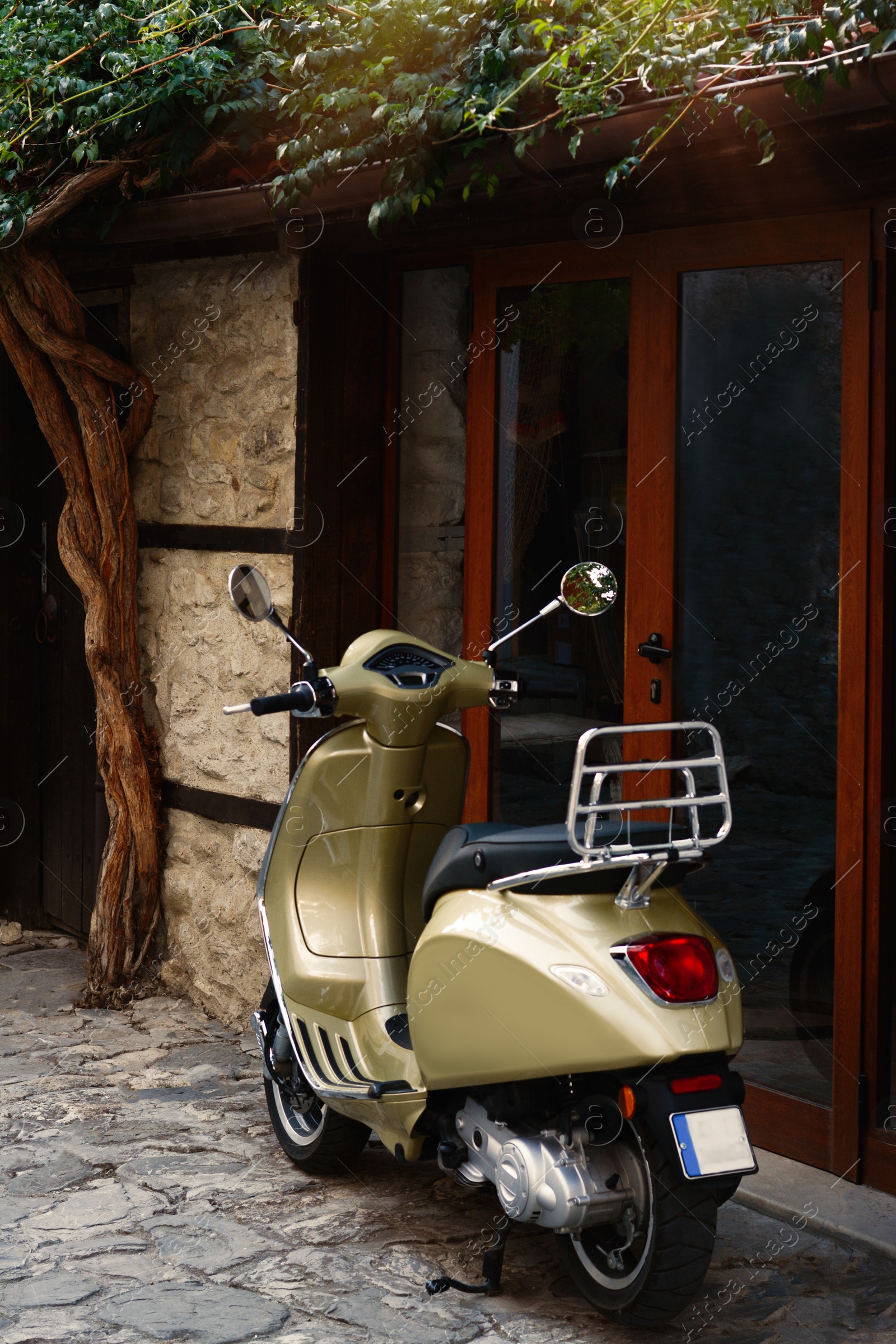 Photo of Beautiful scooter parked near building entrance outdoors