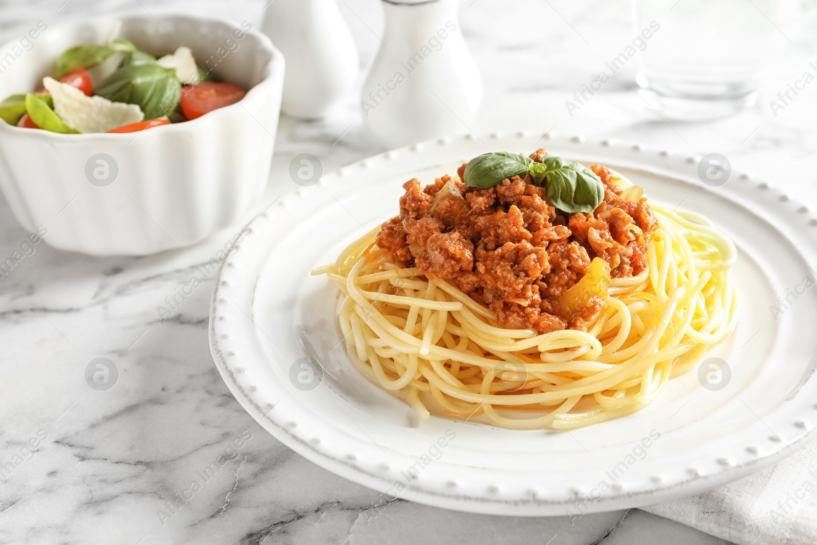 Photo of Plate with delicious pasta bolognese on table