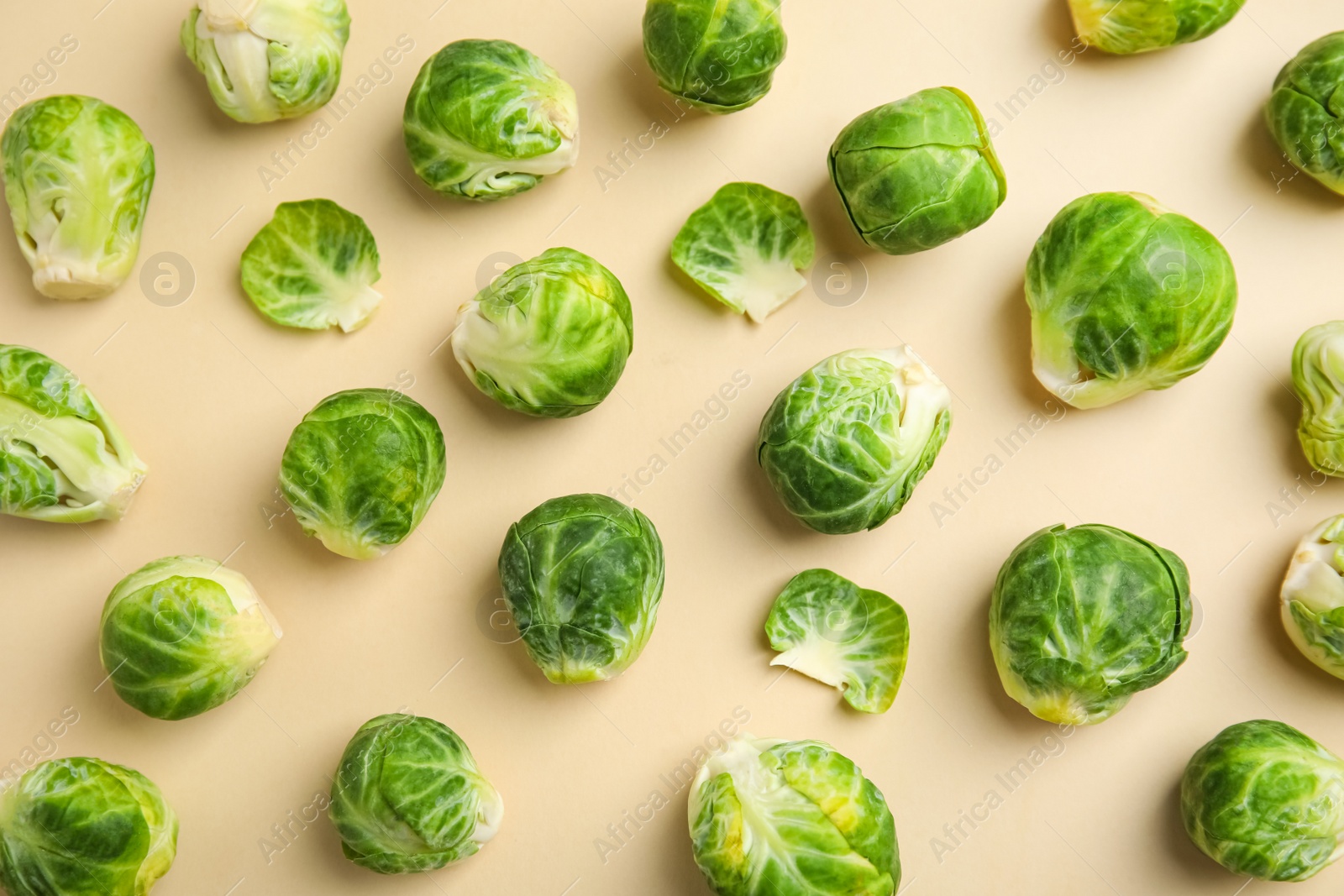 Photo of Fresh Brussels sprouts on beige background, flat lay