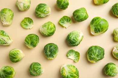 Fresh Brussels sprouts on beige background, flat lay