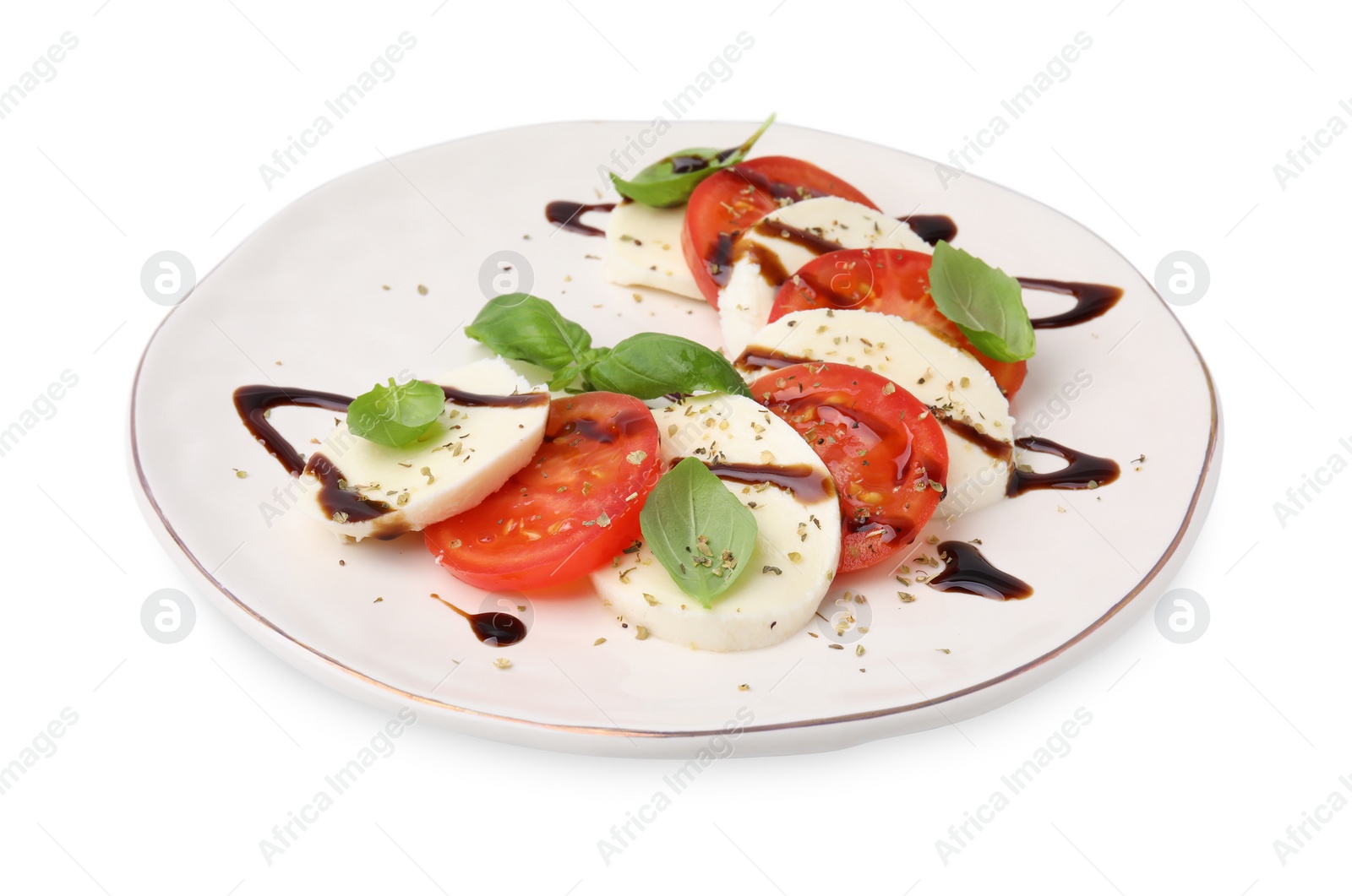 Photo of Plate of delicious Caprese salad with balsamic vinegar isolated on white