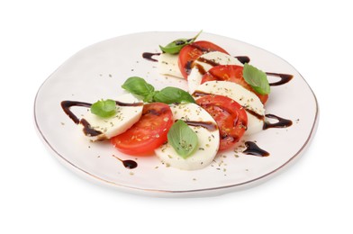 Photo of Plate of delicious Caprese salad with balsamic vinegar isolated on white