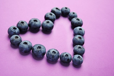 Composition made of tasty blueberry on color background