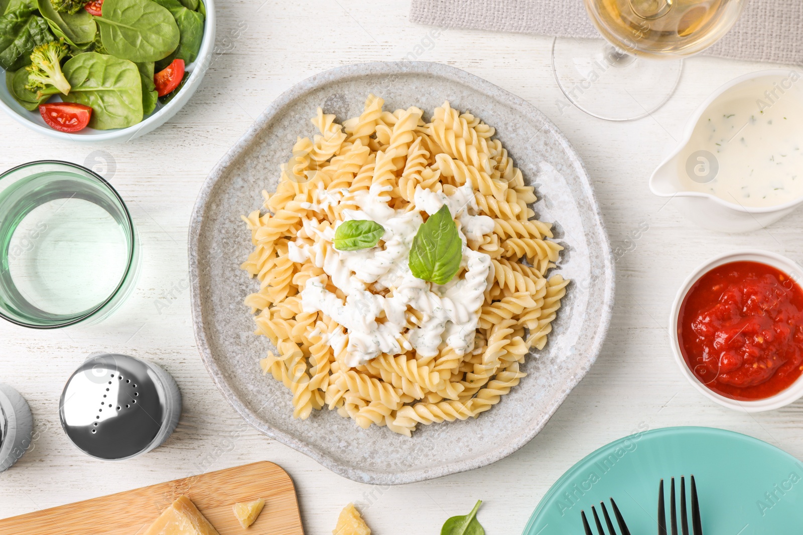 Photo of Flat lay composition with tasty pasta on white wooden table