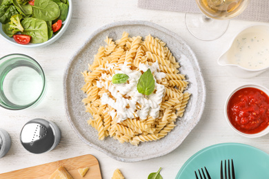 Photo of Flat lay composition with tasty pasta on white wooden table