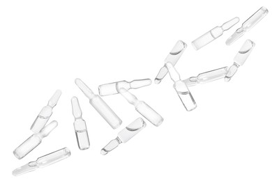 Many glass ampoules with pharmaceutical products falling on white background