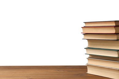 Stack of books on wooden table against white background. Library material