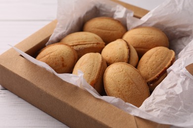 Delicious nut shaped cookies with boiled condensed milk in box, closeup