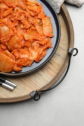 Delicious kimchi with Chinese cabbage on white table, above view