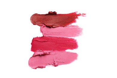Photo of Smears of bright lipsticks on white background, top view