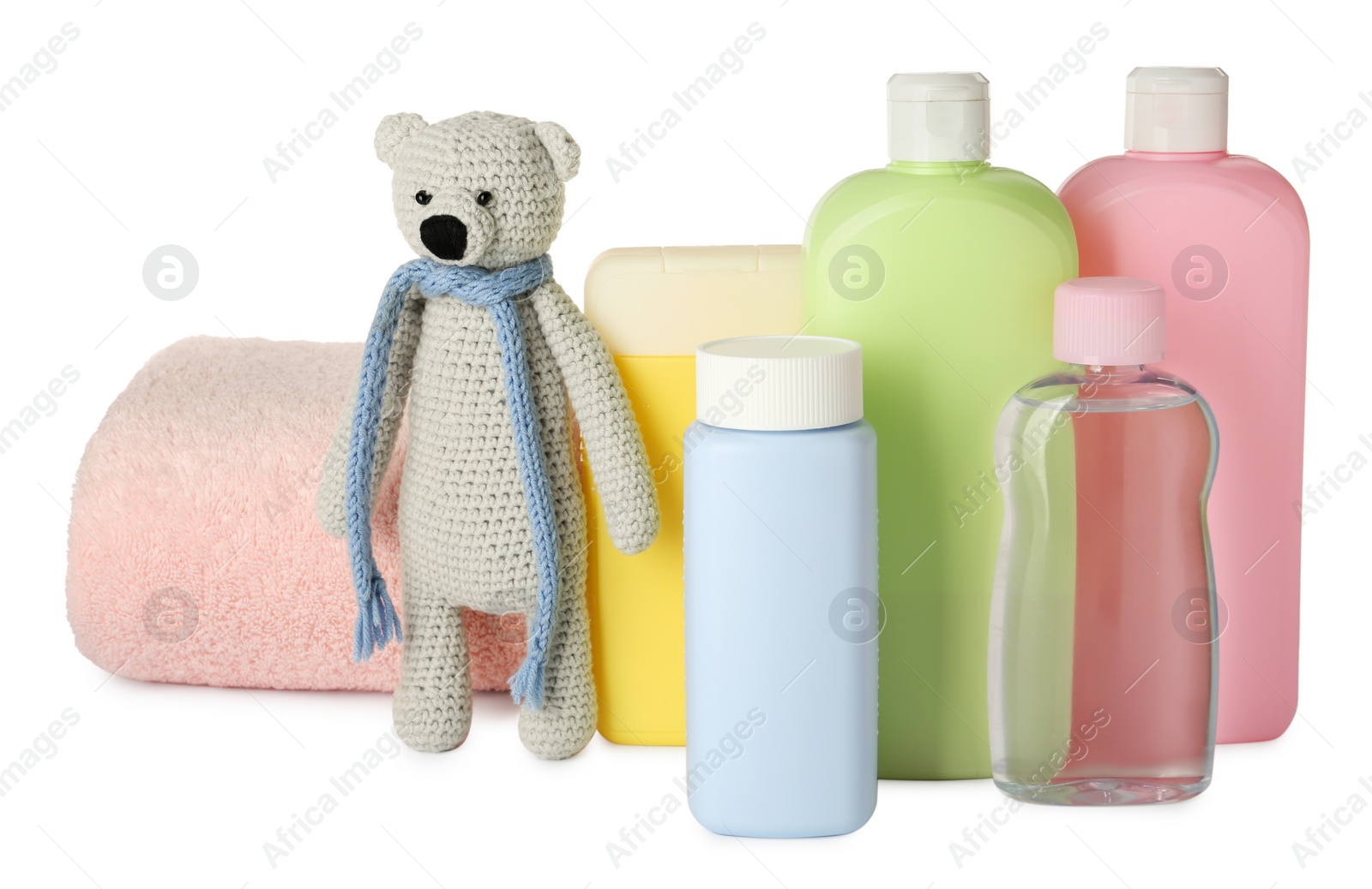 Photo of Bottles of baby cosmetic products, towel and toy bear on white background