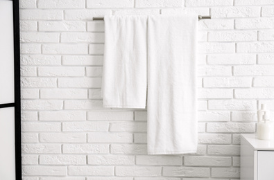 Fresh clean towels on hanger in bathroom