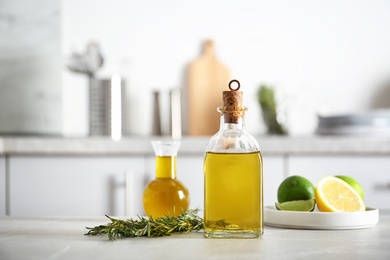 Photo of Composition with fresh rosemary oil on table