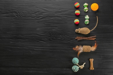Photo of Flat lay composition with cat accessories on dark wooden background