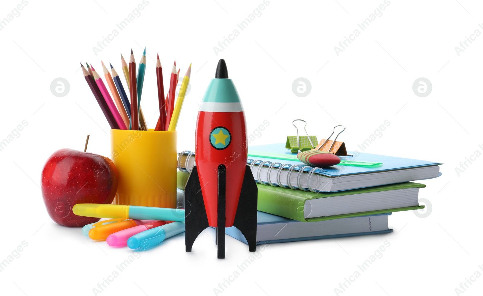 Photo of Bright toy rocket and school supplies on white background