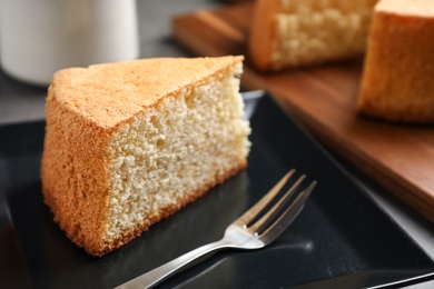 Piece of delicious fresh homemade cake served on grey table