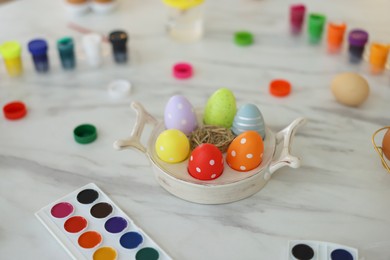 Photo of Happy Easter. Painted eggs and watercolor on white marble table