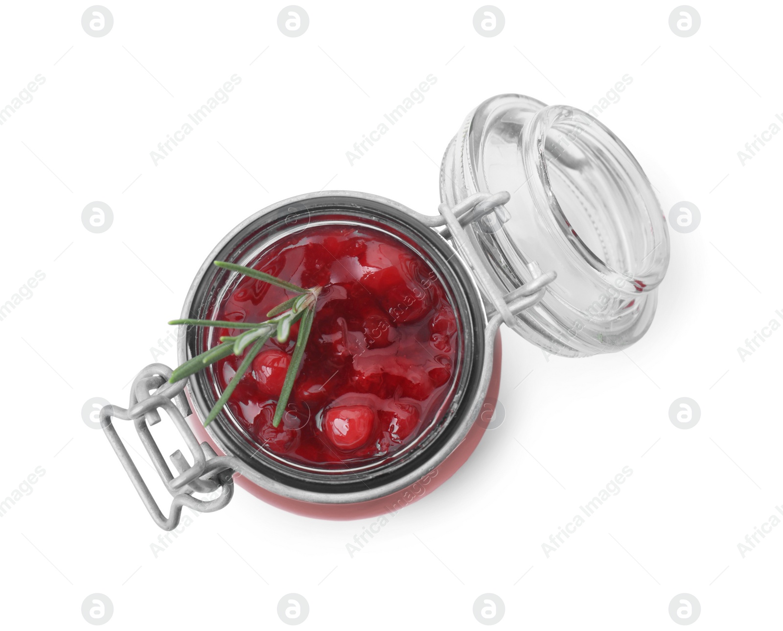 Photo of Fresh cranberry sauce and rosemary in glass jar isolated on white, top view