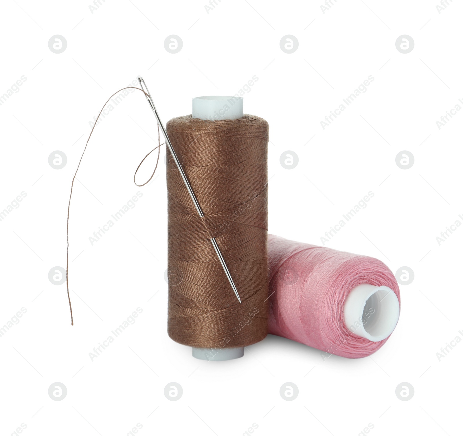 Photo of Different colorful sewing threads and needle on white background